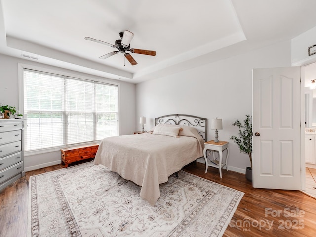 1605 Ambergate Dr, Waxhaw, NC 28173 - bedroom with a tray ceiling, wood finished floors, and a ceiling fan