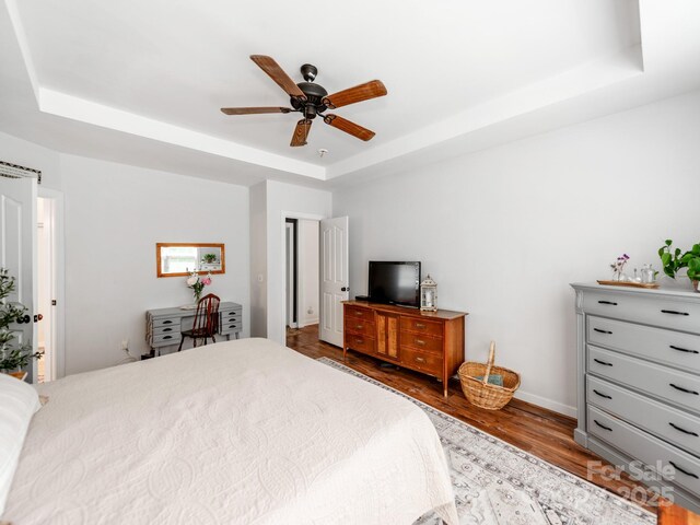 1605 Ambergate Dr, Waxhaw, NC 28173 - bedroom with a raised ceiling, wood finished floors, and a ceiling fan