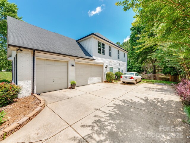 1605 Ambergate Dr, Waxhaw, NC 28173 - view of front of property featuring driveway, brick siding, roof with shingles, and a garage
