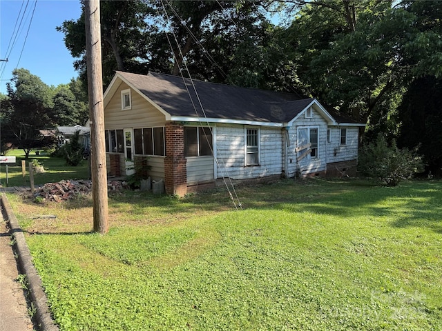 310 E Division Ave, East Spencer, NC 28039 - ranch-style house featuring a front lawn and brick siding