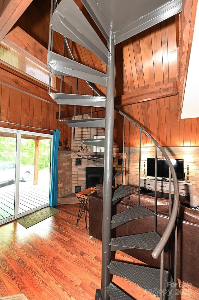 3430 Rose Creek Rd, Morganton, NC 28655 - stairs featuring wood finished floors, wood walls, and a large fireplace
