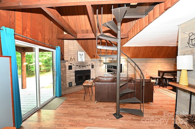 3430 Rose Creek Rd, Morganton, NC 28655 - living room with wood walls, a fireplace, and light wood-style floors