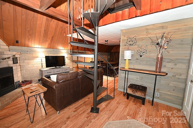 3430 Rose Creek Rd, Morganton, NC 28655 - living room with wooden walls, light wood-style flooring, stairway, and a brick fireplace