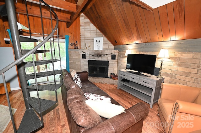 3430 Rose Creek Rd, Morganton, NC 28655 - living area with wood finished floors, wood walls, a brick fireplace, stairs, and wooden ceiling