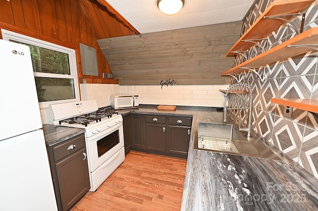 3430 Rose Creek Rd, Morganton, NC 28655 - kitchen with white appliances, decorative backsplash, light wood finished floors, open shelves, and wooden walls