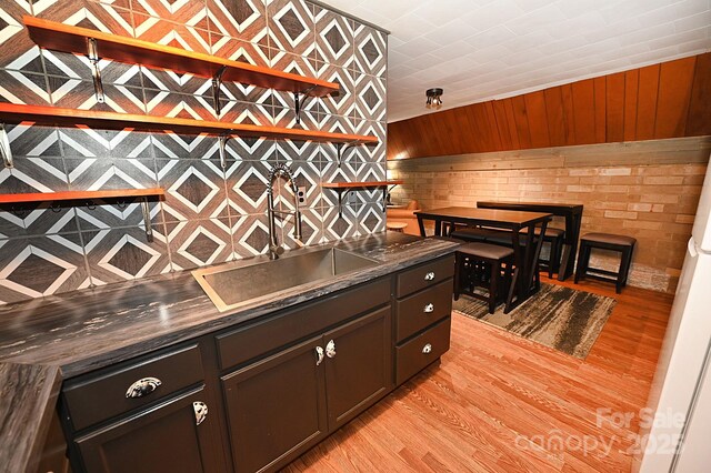 3430 Rose Creek Rd, Morganton, NC 28655 - kitchen featuring dark countertops, light wood-type flooring, and wood walls