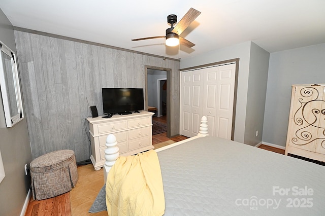 3430 Rose Creek Rd, Morganton, NC 28655 - bedroom featuring a closet, light wood-type flooring, a ceiling fan, and wood walls