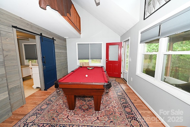 3430 Rose Creek Rd, Morganton, NC 28655 - rec room featuring a barn door, light wood-type flooring, billiards table, wooden walls, and high vaulted ceiling