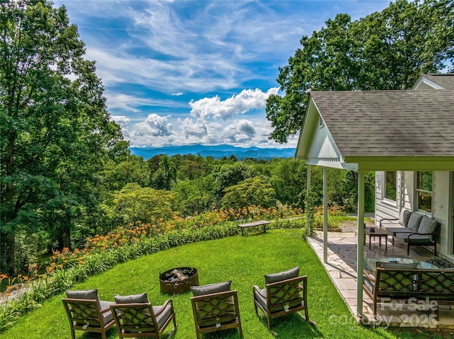170 Twin Springs Rd, Hendersonville, NC 28792 - view of green lawn with an outdoor living space with a fire pit, a patio, and a mountain view