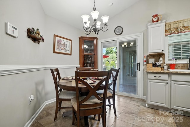 402 Walnut St Unit 11, China Grove, NC 28023 - dining space with a chandelier, vaulted ceiling, and light tile patterned floors