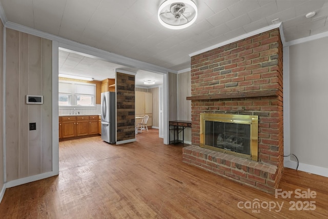 435 Stirewalt Rd, China Grove, NC 28023 - unfurnished living room with crown molding, light wood-type flooring, and a fireplace