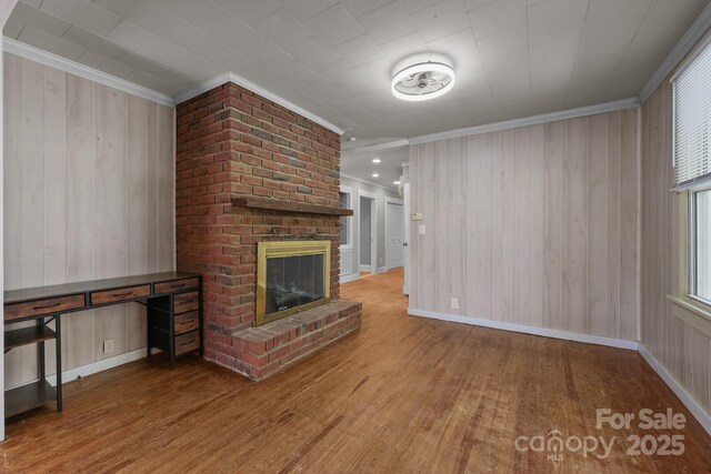 435 Stirewalt Rd, China Grove, NC 28023 - unfurnished living room with ornamental molding, wood finished floors, a fireplace, and wood walls