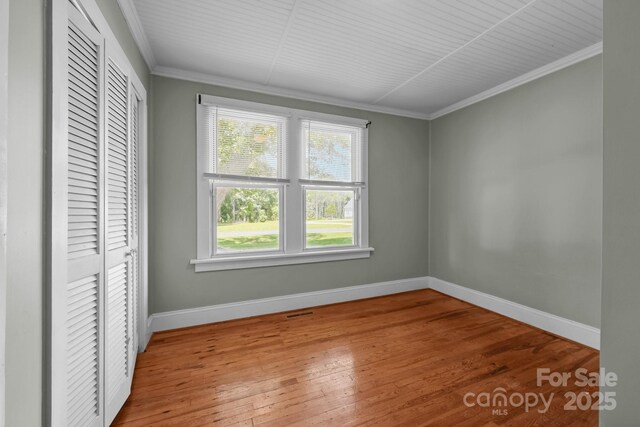 435 Stirewalt Rd, China Grove, NC 28023 - unfurnished bedroom with a closet, ornamental molding, and hardwood / wood-style flooring