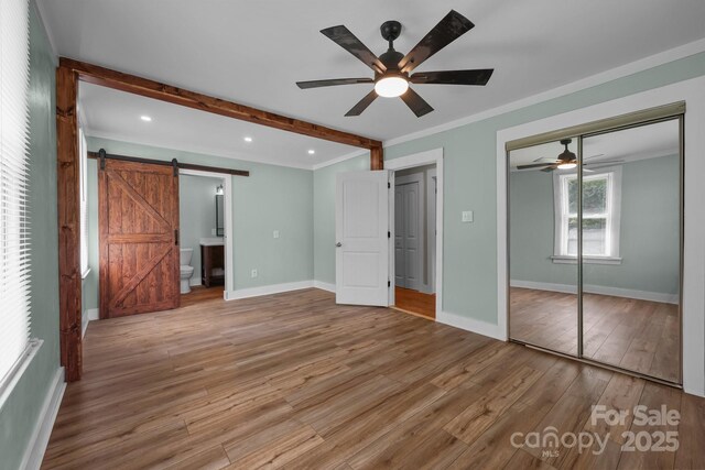 435 Stirewalt Rd, China Grove, NC 28023 - unfurnished bedroom featuring a barn door, light wood-type flooring, crown molding, recessed lighting, and ceiling fan
