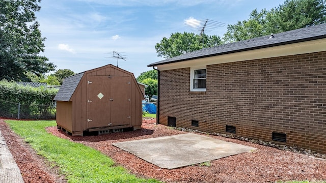 1040 Stagecoach Trl, Lenoir, NC 28645 - view of home's exterior with crawl space, a patio area, a shed, and brick siding