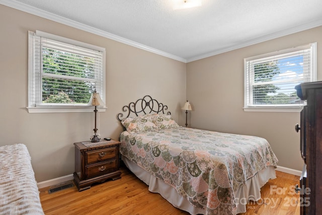 1040 Stagecoach Trl, Lenoir, NC 28645 - bedroom featuring multiple windows, light wood-style flooring, and crown molding