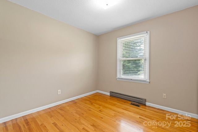 1040 Stagecoach Trl, Lenoir, NC 28645 - empty room with baseboard heating and light wood-type flooring