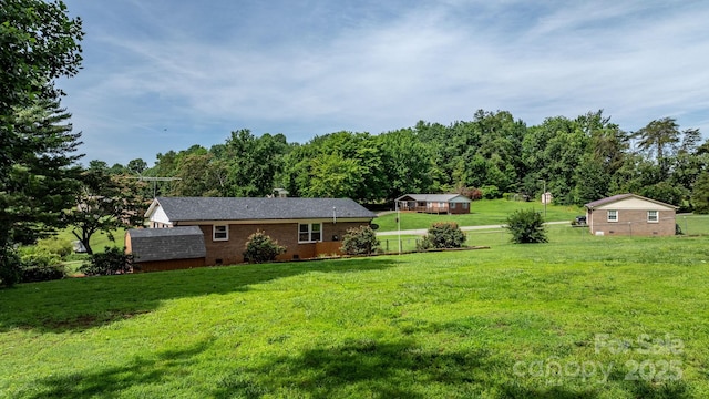 1040 Stagecoach Trl, Lenoir, NC 28645 - view of grassy yard with a storage shed
