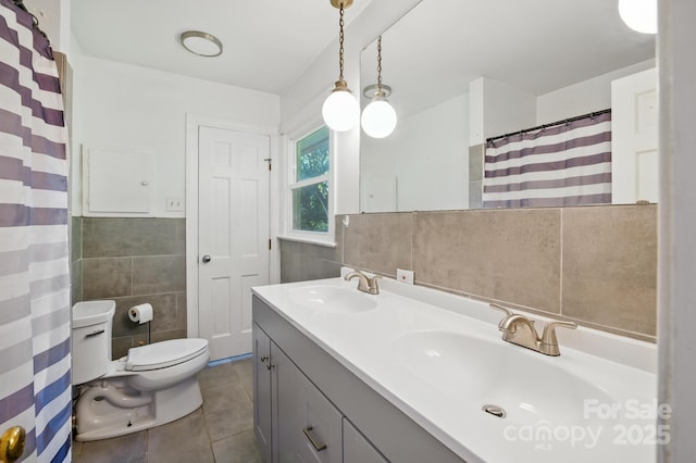 310 25th Ave NW, Hickory, NC 28601 - full bath with tile walls, tile patterned floors, double vanity, and a wainscoted wall