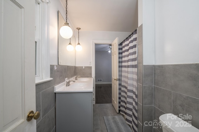 310 25th Ave NW, Hickory, NC 28601 - bathroom with tile walls, vanity, a wainscoted wall, and a shower with curtain