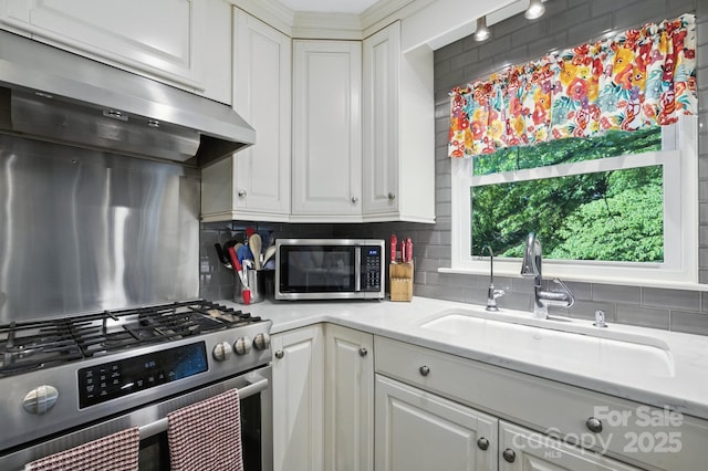 310 25th Ave NW, Hickory, NC 28601 - kitchen with appliances with stainless steel finishes, ventilation hood, backsplash, and white cabinets