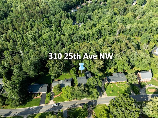 310 25th Ave NW, Hickory, NC 28601 - aerial view of property and surrounding area with a heavily wooded area