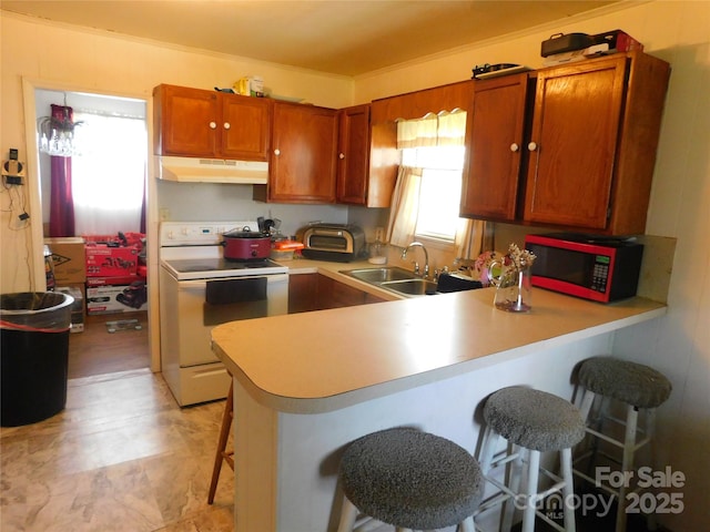 814 Aileen Cir, Pineville, NC 28134 - kitchen featuring electric stove, under cabinet range hood, a breakfast bar, a peninsula, and light countertops