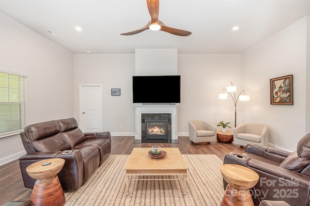 7739 Village Pkwy, Locust, NC 28097 - living area featuring wood finished floors, ceiling fan, a fireplace with flush hearth, and recessed lighting
