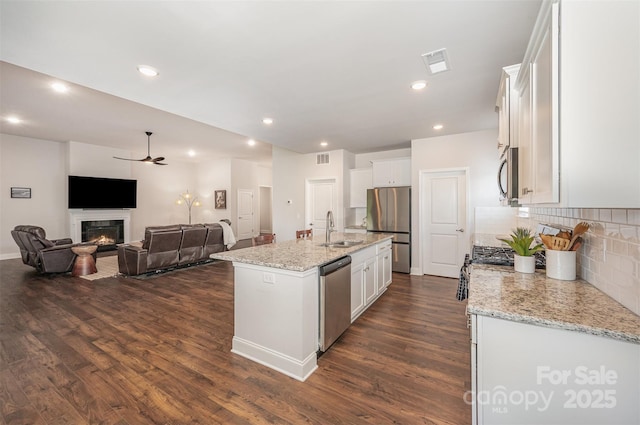 7739 Village Pkwy, Locust, NC 28097 - kitchen with appliances with stainless steel finishes, ceiling fan, dark wood-style floors, open floor plan, and recessed lighting