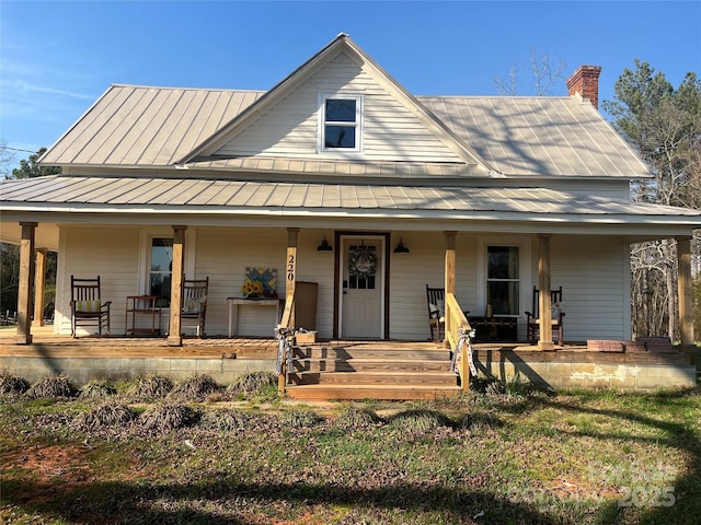 220 Low Water Bridge Rd, Troy, NC 27371 - farmhouse inspired home with a porch, a standing seam roof, a chimney, and a metal roof
