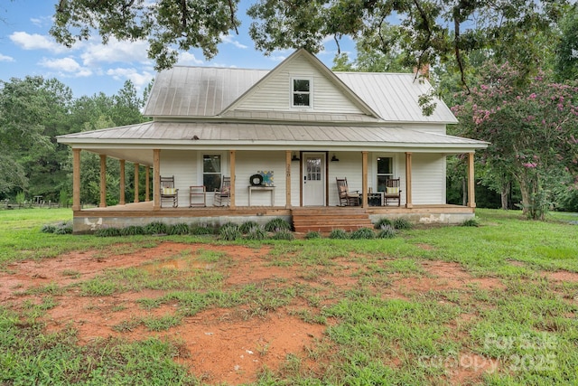 220 Low Water Bridge Rd, Troy, NC 27371 - country-style home featuring a porch, a metal roof, and a front yard