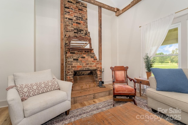 220 Low Water Bridge Rd, Troy, NC 27371 - sitting room with wood finished floors, a fireplace, and a towering ceiling