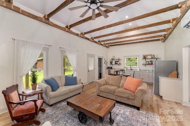 220 Low Water Bridge Rd, Troy, NC 27371 - living area featuring light wood finished floors, a ceiling fan, beam ceiling, a wall unit AC, and recessed lighting