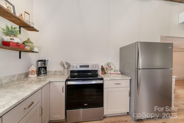 220 Low Water Bridge Rd, Troy, NC 27371 - kitchen with appliances with stainless steel finishes, open shelves, light wood-type flooring, and light stone countertops