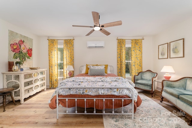 220 Low Water Bridge Rd, Troy, NC 27371 - bedroom with a wall mounted air conditioner, wood finished floors, and ceiling fan