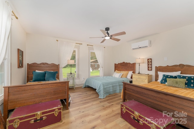 220 Low Water Bridge Rd, Troy, NC 27371 - bedroom featuring an AC wall unit, light wood-type flooring, and ceiling fan
