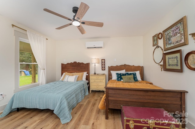 220 Low Water Bridge Rd, Troy, NC 27371 - bedroom with a wall mounted AC, light wood finished floors, and ceiling fan