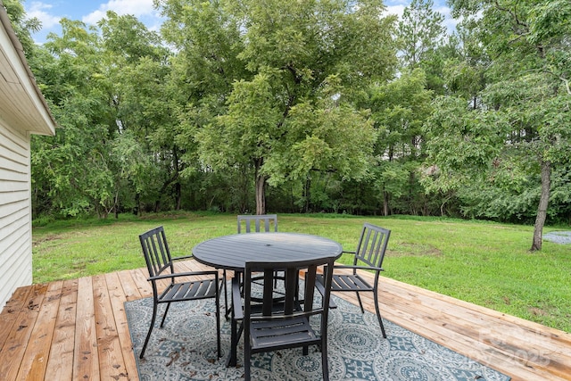 220 Low Water Bridge Rd, Troy, NC 27371 - wooden terrace featuring outdoor dining area, a lawn, and view of wooded area