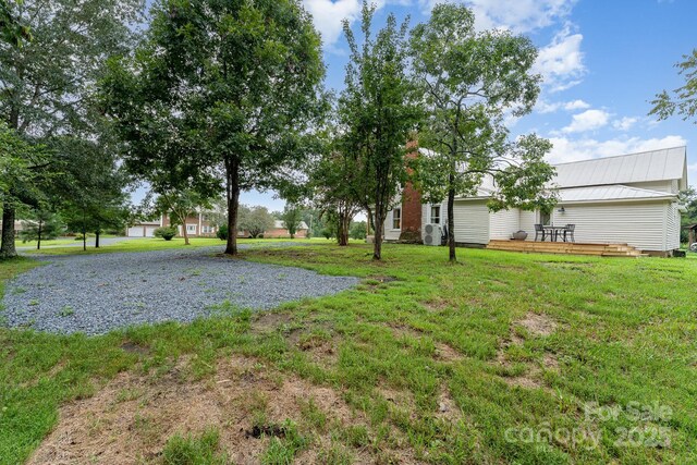 220 Low Water Bridge Rd, Troy, NC 27371 - view of grassy yard featuring a deck and driveway
