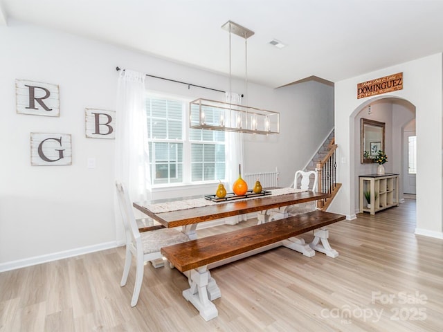 4268 Coachwhip Ave, Lancaster, SC 29720 - dining room featuring arched walkways, light wood-style floors, stairs, and a chandelier