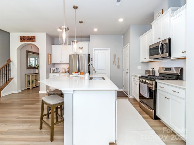 4268 Coachwhip Ave, Lancaster, SC 29720 - kitchen with stainless steel appliances, light wood-style flooring, light countertops, a center island with sink, and recessed lighting