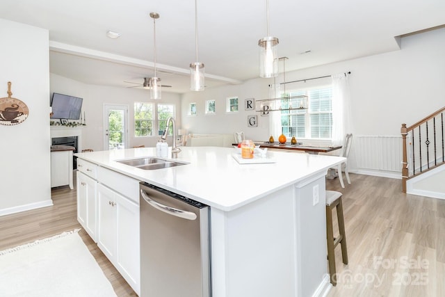 4268 Coachwhip Ave, Lancaster, SC 29720 - kitchen with dishwasher, light wood finished floors, a fireplace, white cabinets, and a kitchen island with sink