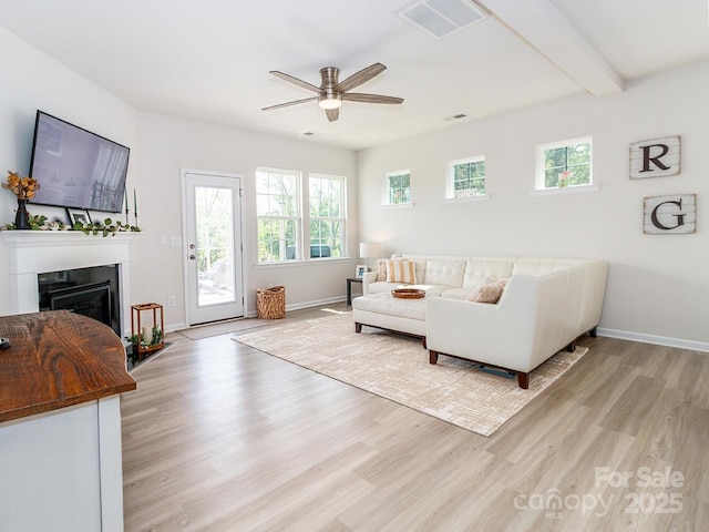 4268 Coachwhip Ave, Lancaster, SC 29720 - living area featuring a ceiling fan, light wood-style flooring, healthy amount of natural light, a glass covered fireplace, and beam ceiling