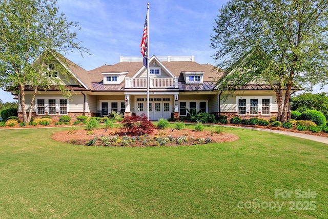 4268 Coachwhip Ave, Lancaster, SC 29720 - view of front of house featuring french doors, a standing seam roof, a front lawn, stone siding, and a metal roof