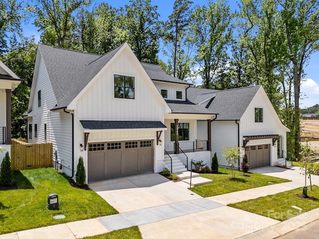 3949 Plainview Rd, Charlotte, NC 28208 - modern farmhouse style home featuring a shingled roof, an attached garage, concrete driveway, and board and batten siding