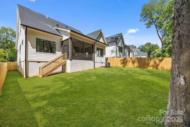 3949 Plainview Rd, Charlotte, NC 28208 - back of property with a sunroom, a fenced backyard, stairway, roof with shingles, and ceiling fan