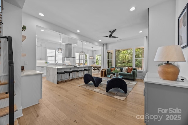 3949 Plainview Rd, Charlotte, NC 28208 - living room featuring a ceiling fan, light wood finished floors, recessed lighting, and healthy amount of natural light