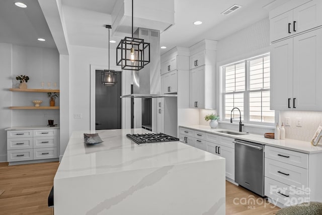 3949 Plainview Rd, Charlotte, NC 28208 - kitchen with appliances with stainless steel finishes, a kitchen island, white cabinetry, light stone counters, and recessed lighting