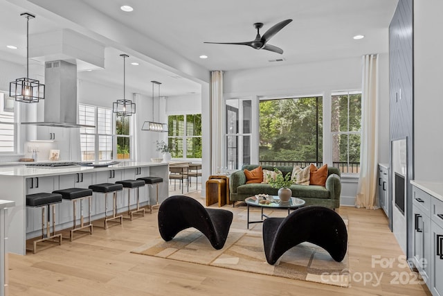 3949 Plainview Rd, Charlotte, NC 28208 - living room featuring light wood finished floors, ceiling fan, a chandelier, and recessed lighting
