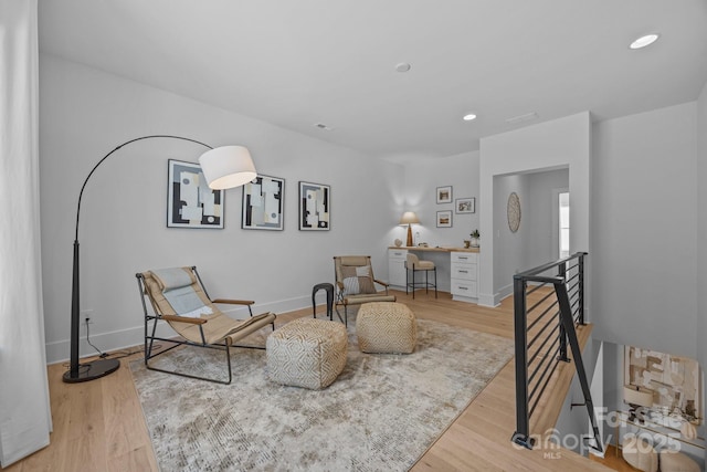 3949 Plainview Rd, Charlotte, NC 28208 - sitting room with an upstairs landing, light wood-style floors, and recessed lighting